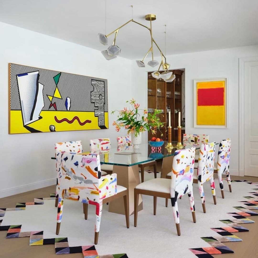 Bold abstract painting with geometric shapes hanging in a colorful modern dining room