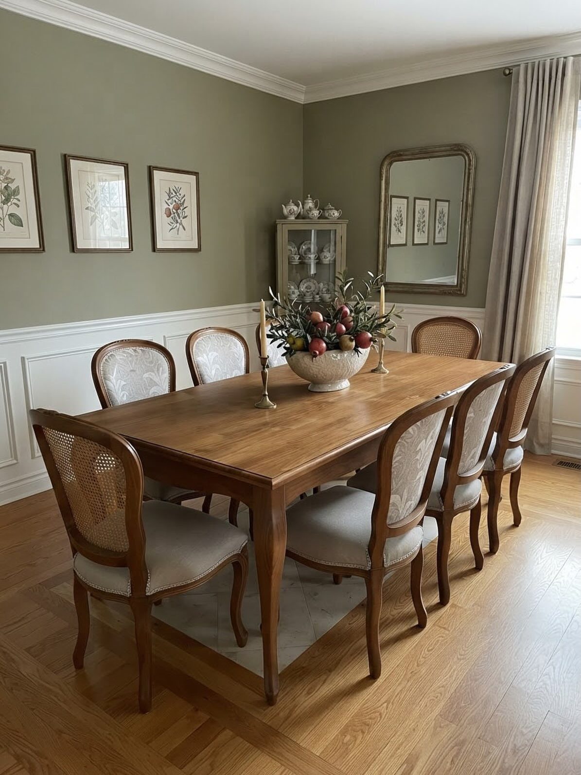 Wooden dining table and chairs in a room with olive green walls.