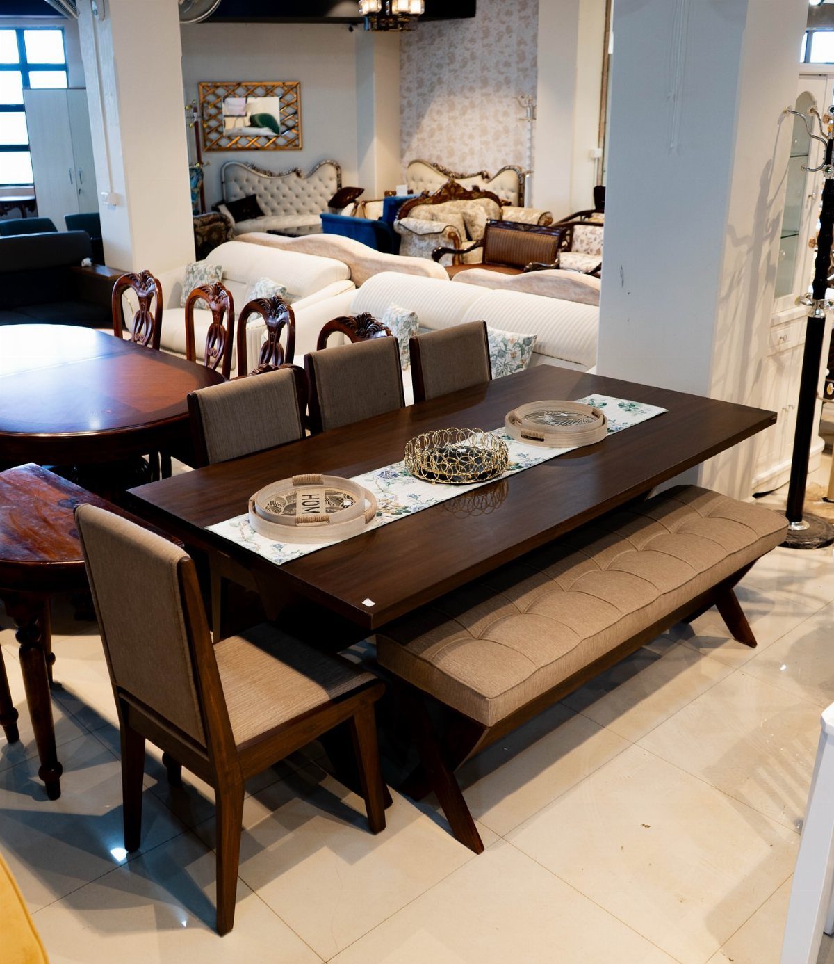 Dark brown rectangular dining table with grey upholstered chairs and a matching bench.