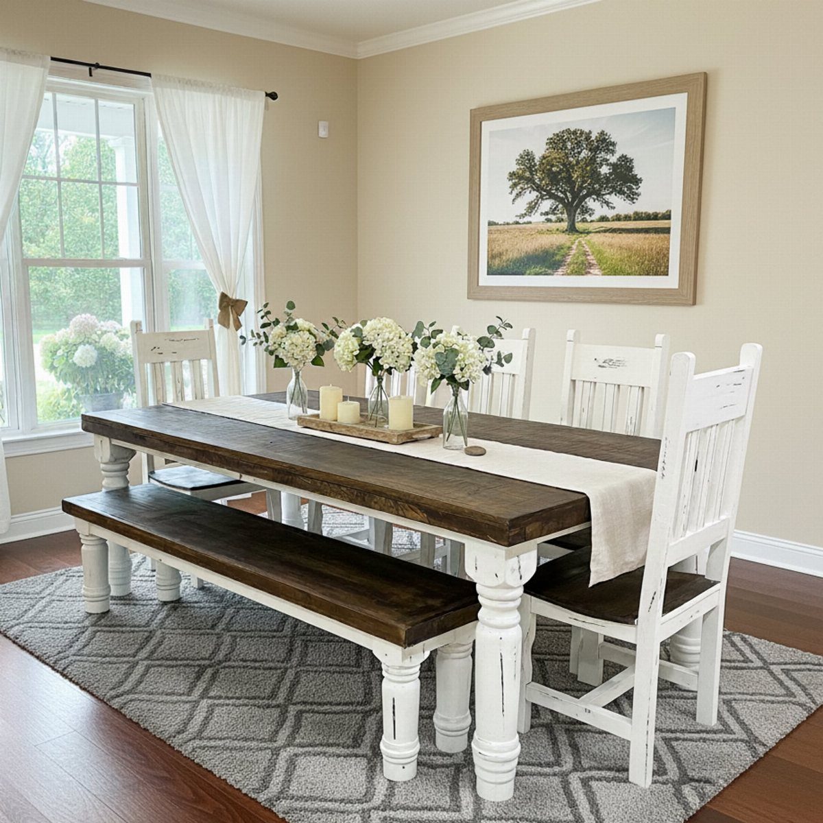 Rustic farmhouse dining table with dark wood top, white legs, bench, and chairs.
