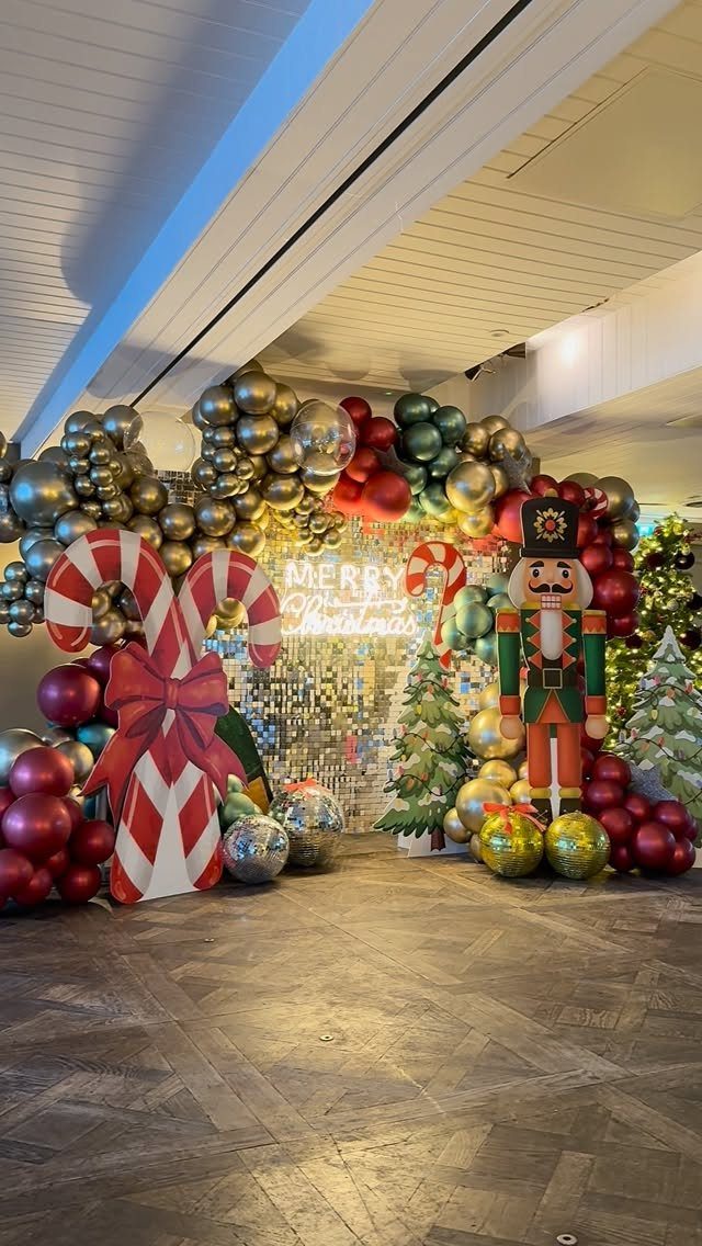 Christmas decorations including balloons, candy canes, and a nutcracker in an office lobby