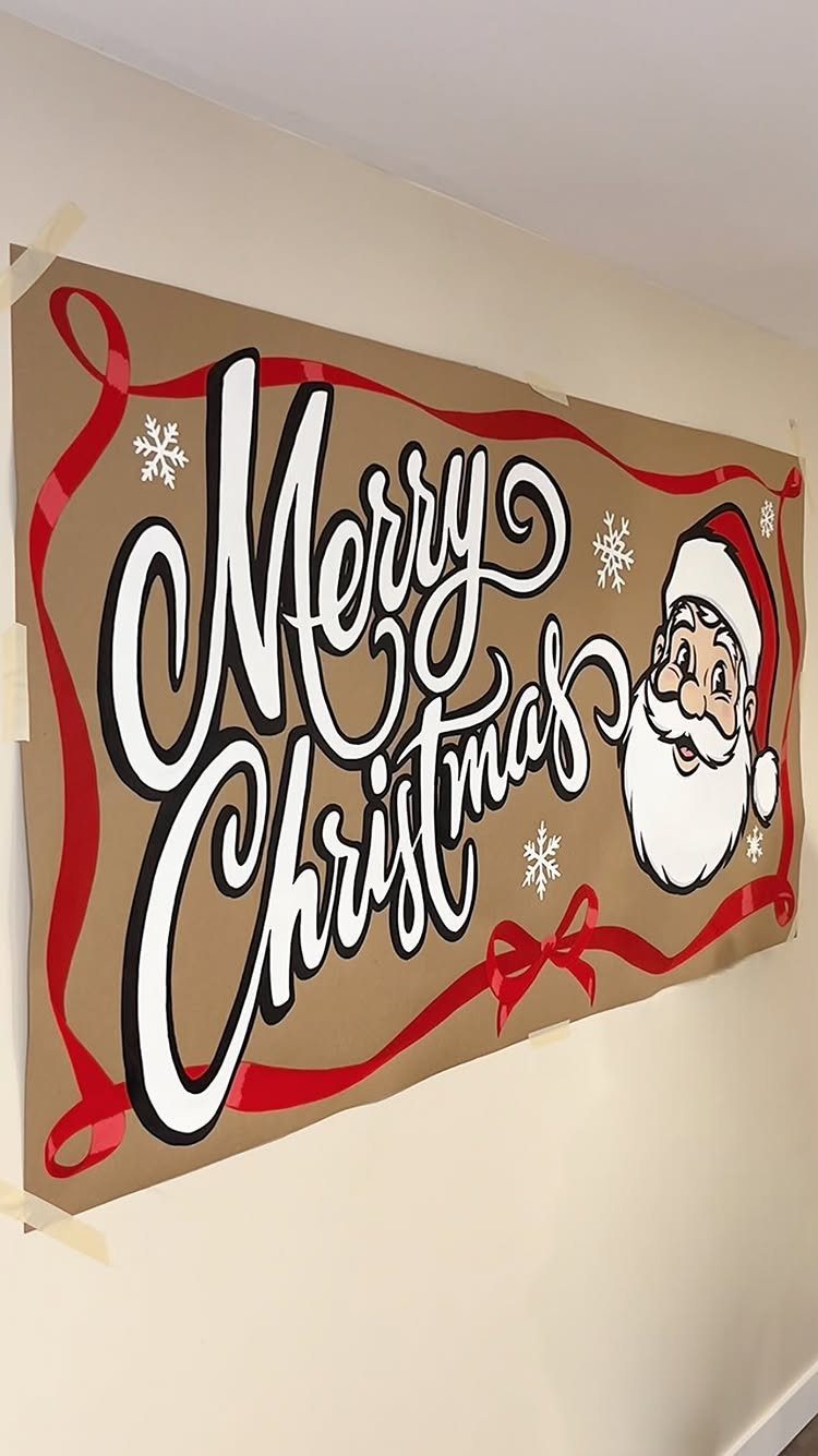 Brown paper Christmas banner with Merry Christmas text and Santa Claus on wall