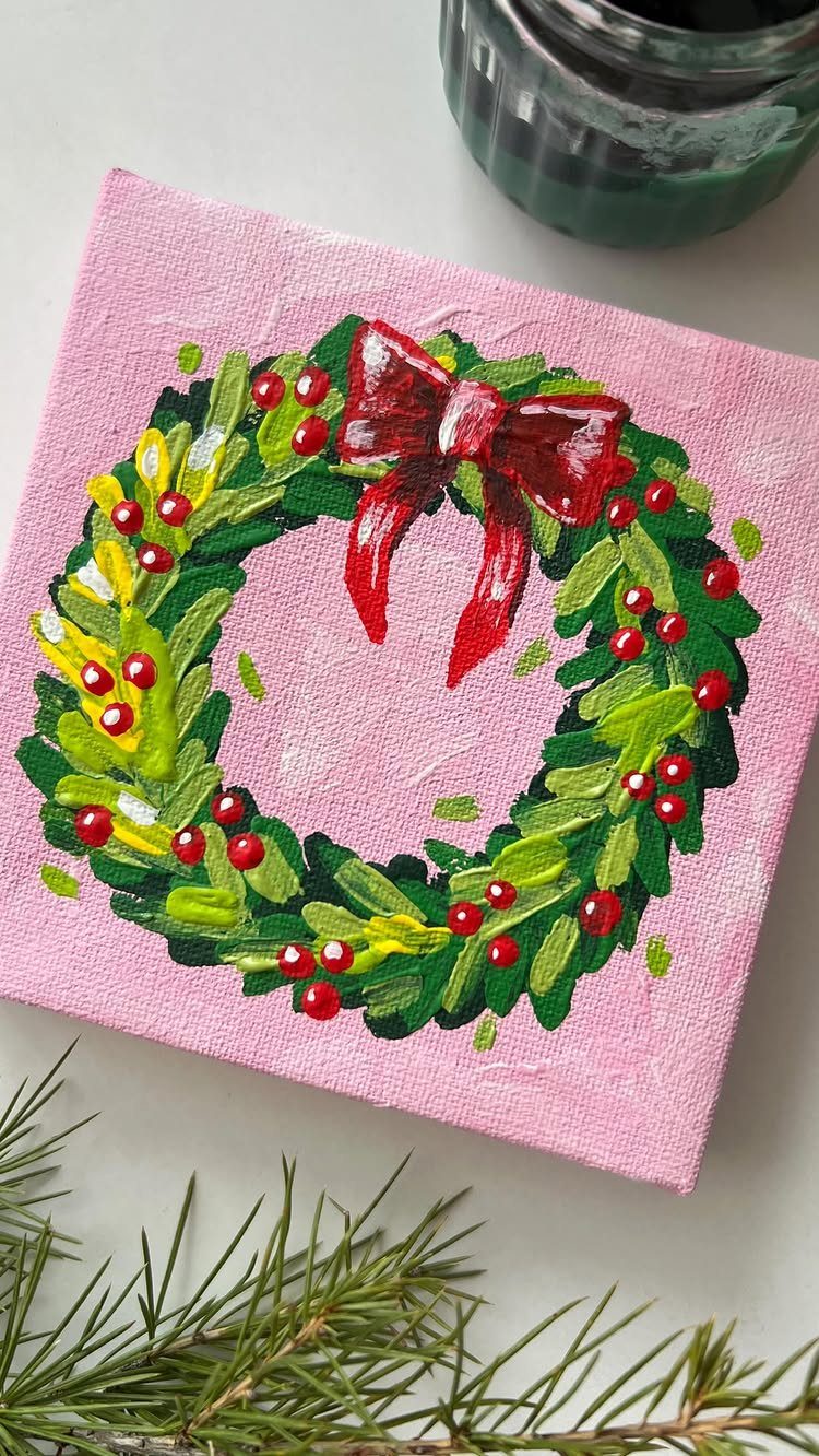 Painted Christmas wreath with red bow on a small pink canvas background