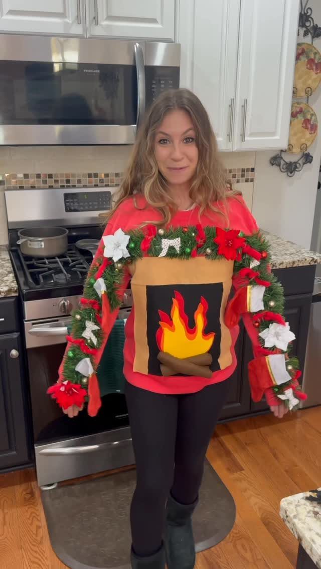 Woman wearing a red ugly Christmas sweater with a 3D fireplace design