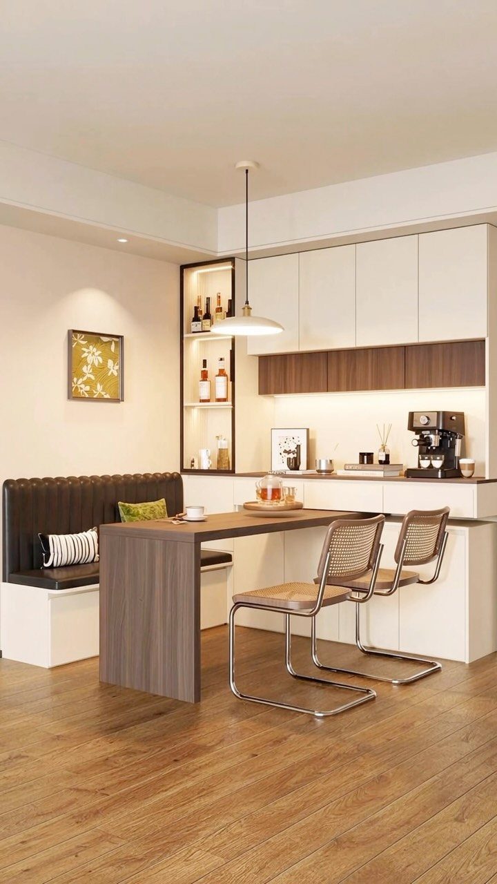 Dining area with a wooden table, built-in bench, and recessed wall storage shelves.