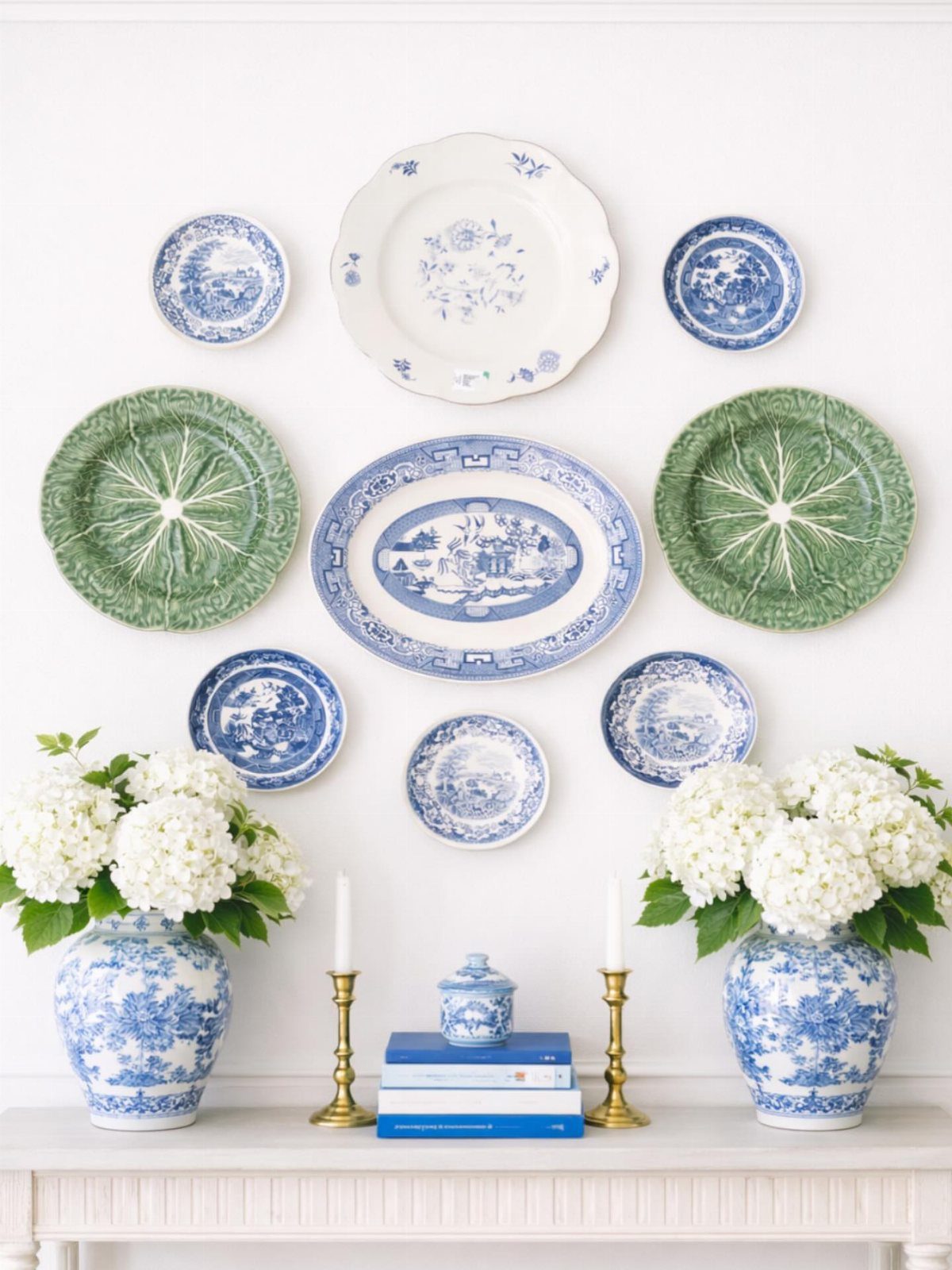 Decorative blue, white, and green plates arranged on a white dining room wall.