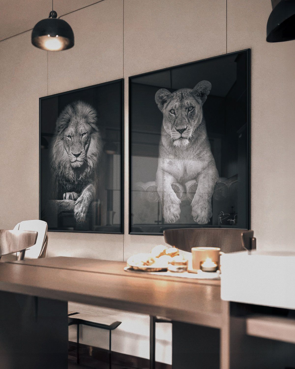 Two large black and white lion portraits in black frames on a beige wall.