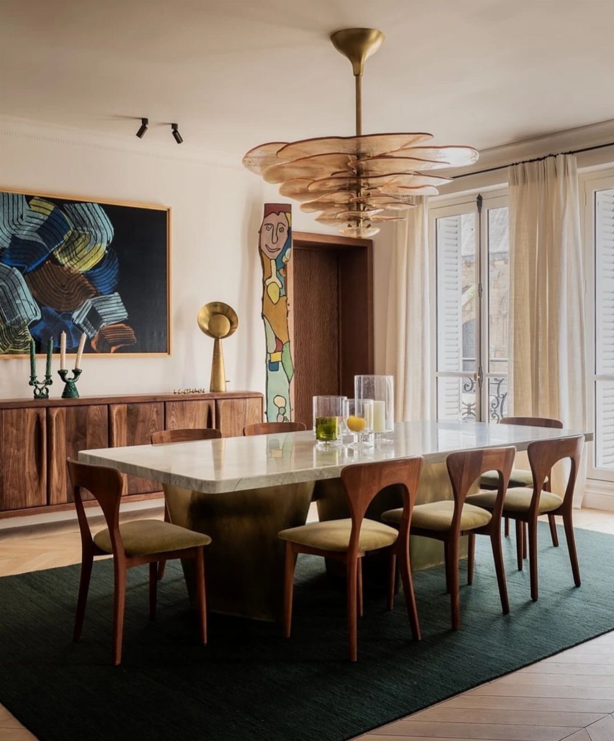 Large abstract painting on a wall in a mid-century modern dining room.