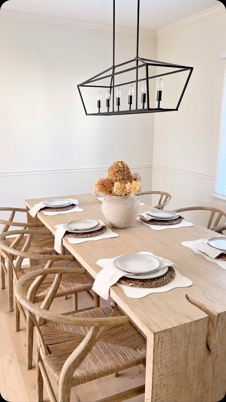 Round woven placemats under white plates on a light wood dining table.