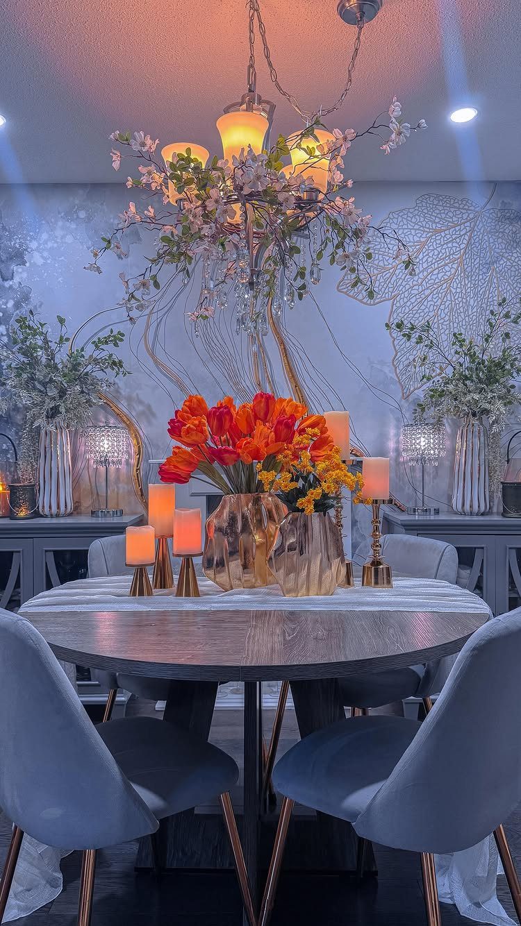 Dining room with orange tulips on a grey table and botanical wall mural.