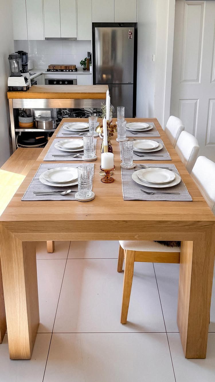 Wooden dining table set for four in an open concept kitchen living area