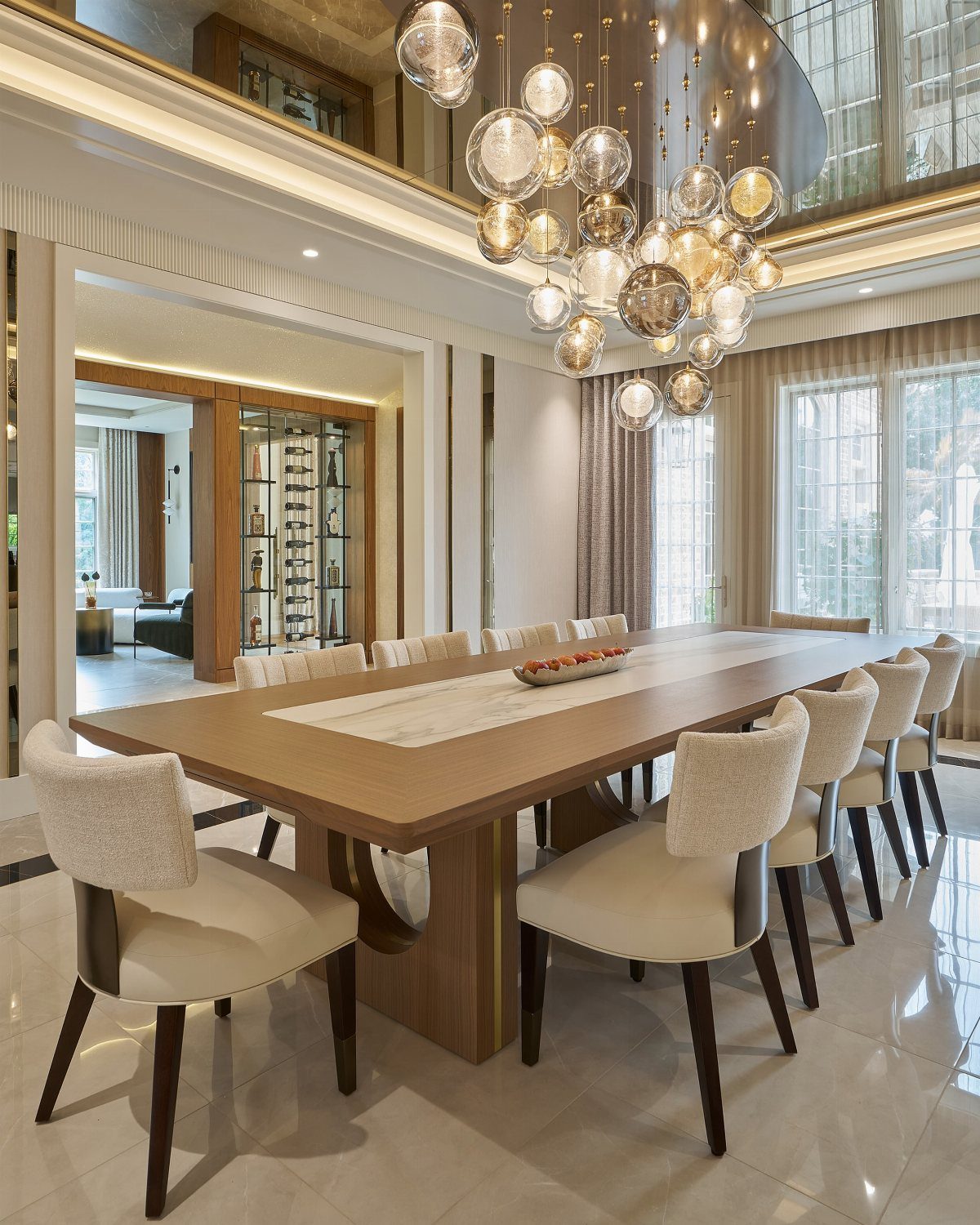 Modern dining room with a long wooden table and a large globe chandelier.