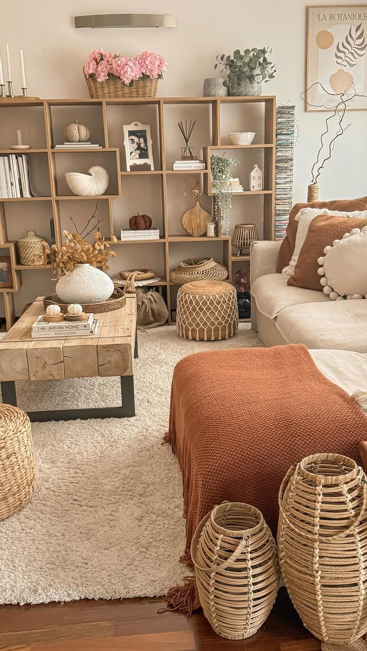 Cozy living room with wooden furniture, woven baskets, and green potted plants.