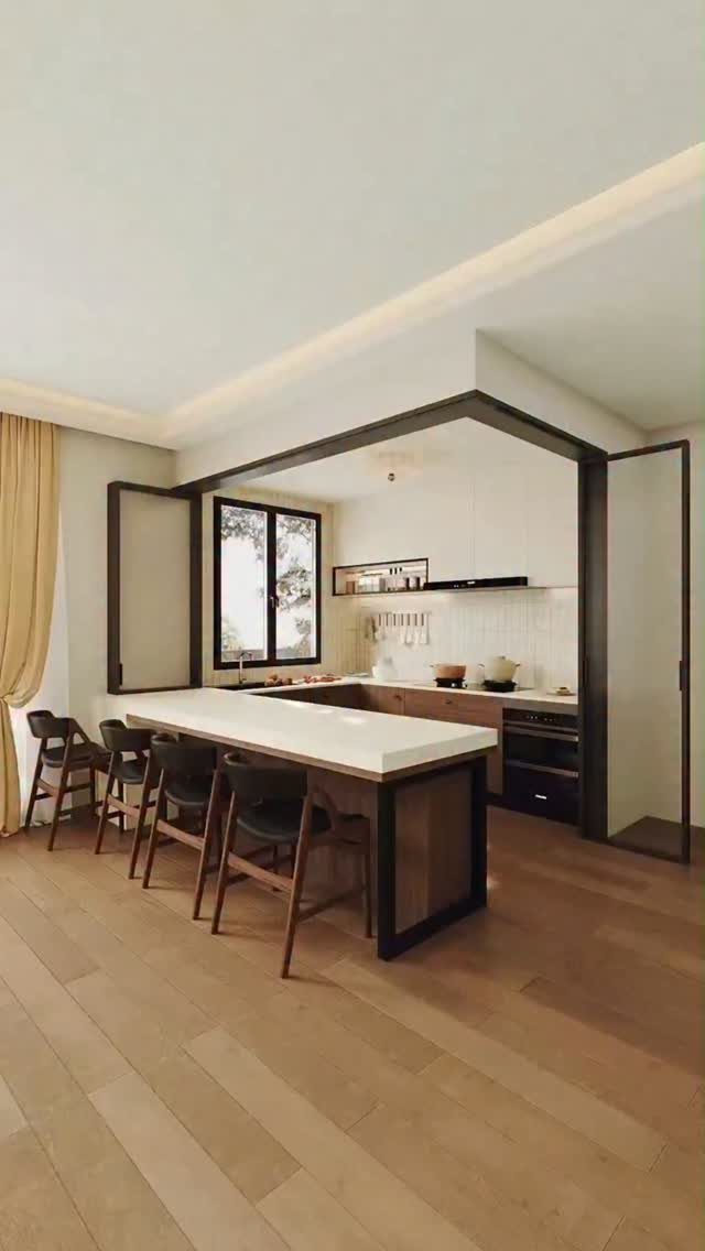 Modern open kitchen with a white island and dark wooden bar stools.