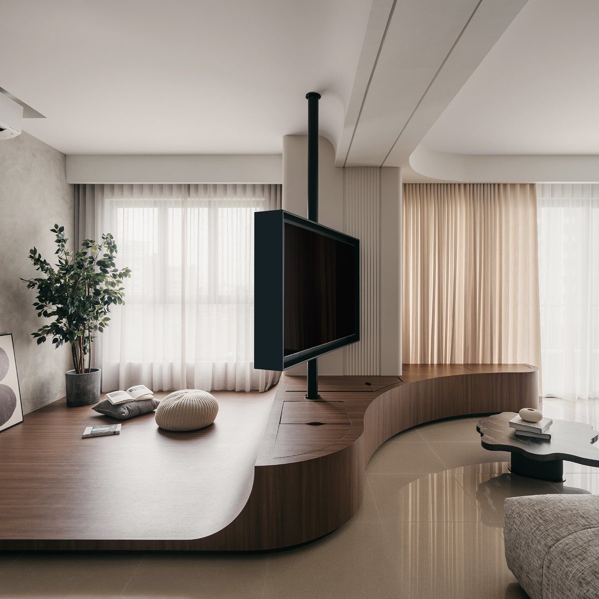 Modern living room with a curved wooden partition holding a black television screen.