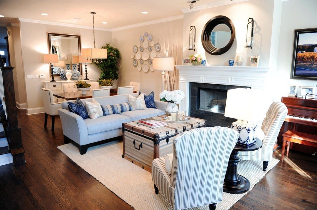 Open concept living and dining area with blue sofa and adjacent dining table