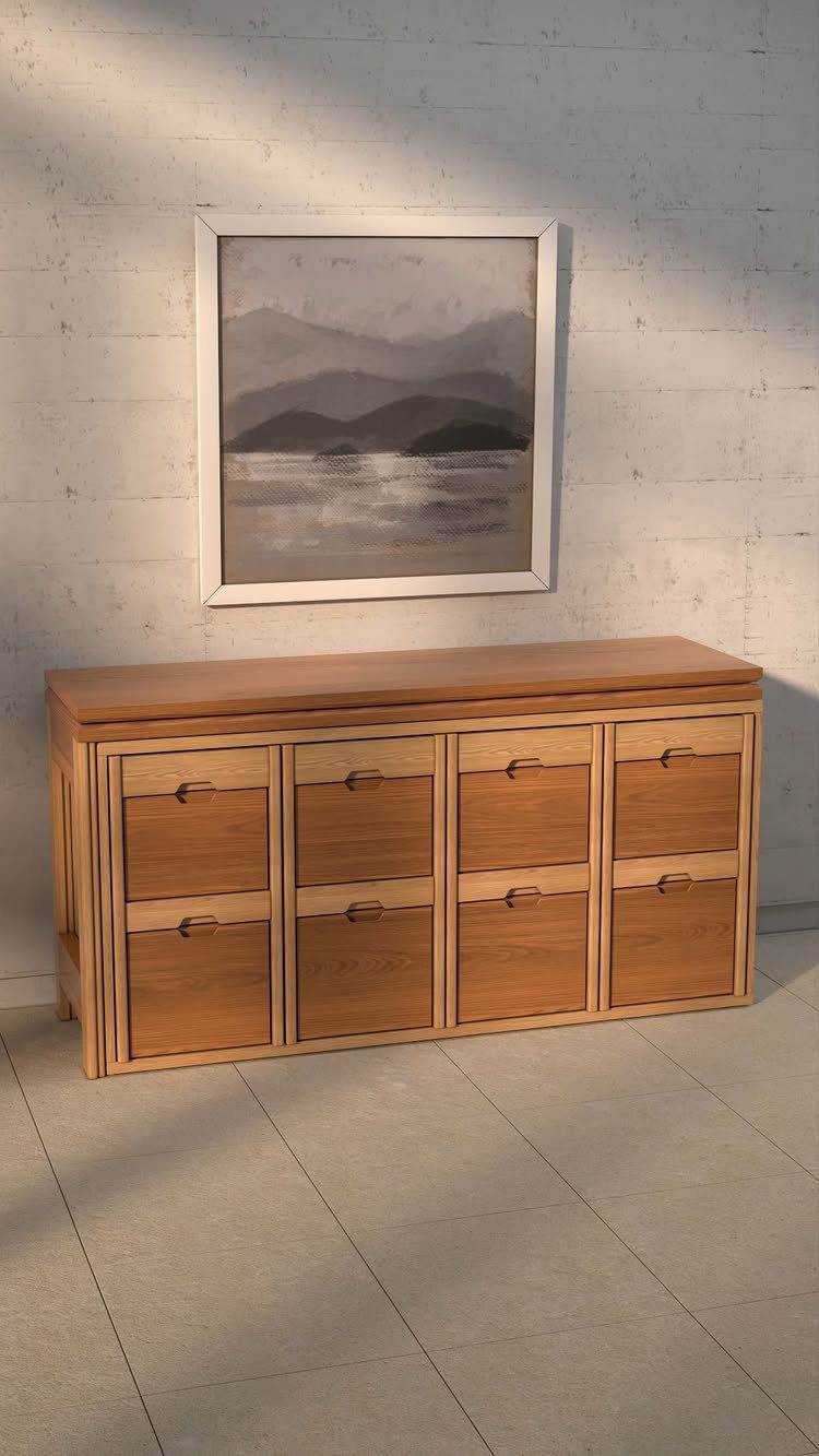 Wooden sideboard cabinet with drawers under a framed abstract landscape painting on white wall
