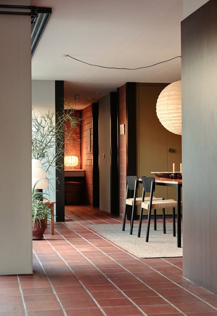 Large white spherical paper lantern hanging over a mid-century modern dining table