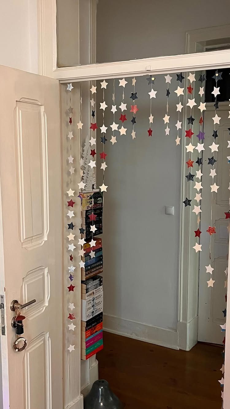 Star-shaped ornaments in red, white, and blue hanging across a white doorway.