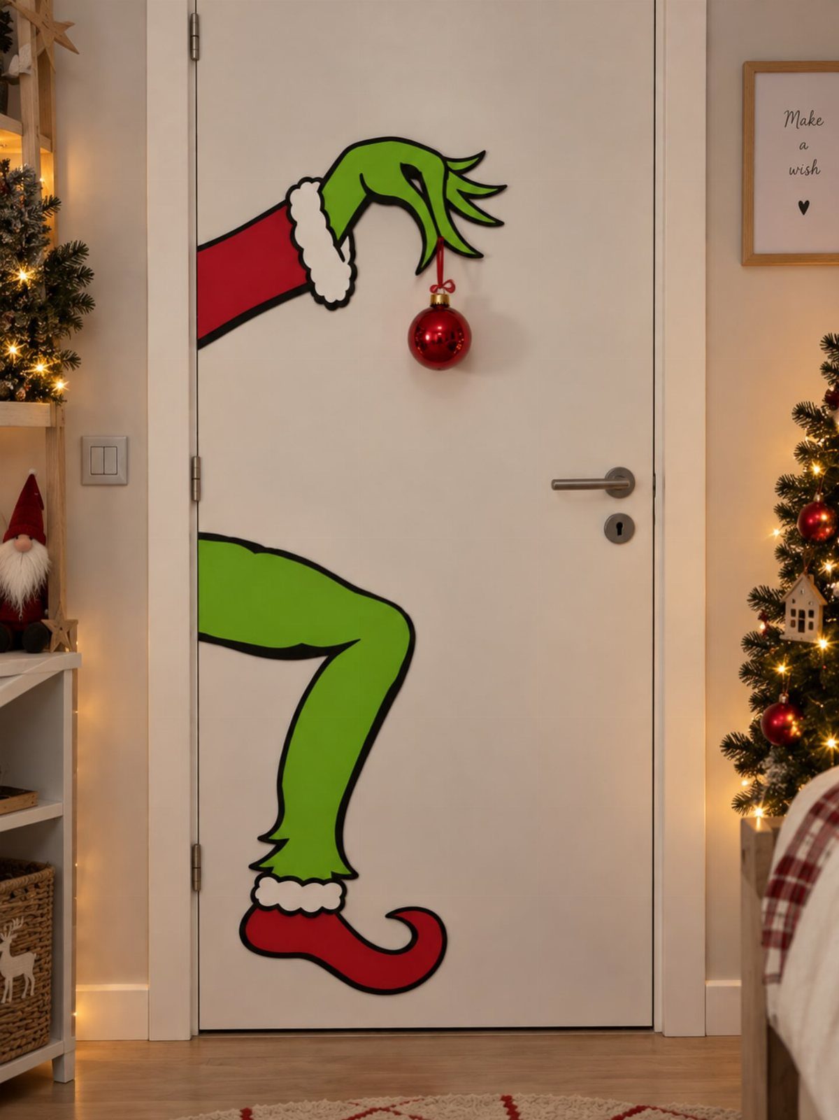 White door with Grinch cartoon decals and a hanging red Christmas ornament