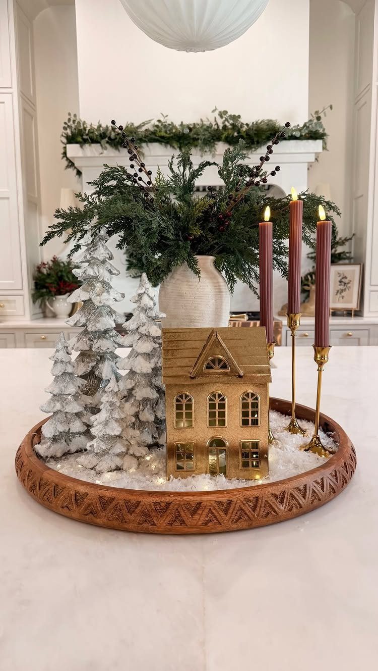 Snowy white trees and a gold house in a wooden dough bowl centerpiece.