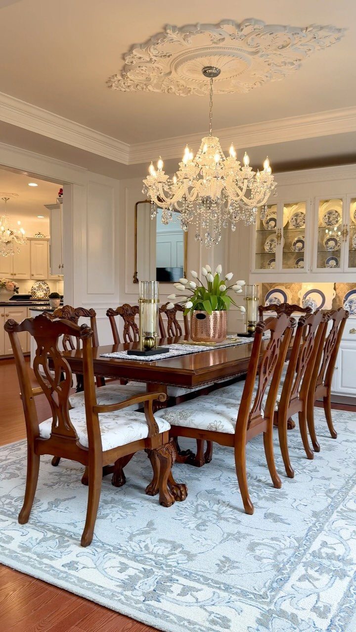 Light blue and white patterned area rug under a wooden dining table set.