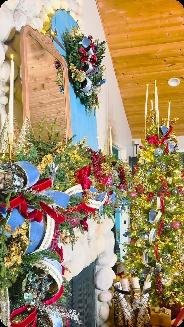 Evergreen garland with red and blue ribbons draped over a stone fireplace