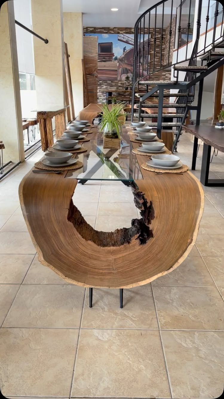 Oval wood slab dining table with glass center and grey place settings